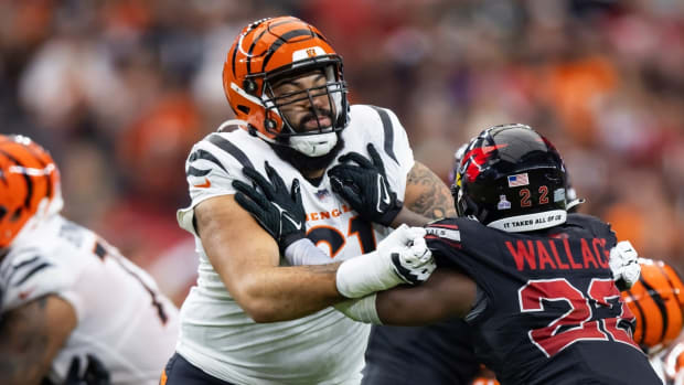Oct 8, 2023; Glendale, Arizona, USA; Cincinnati Bengals offensive tackle Cody Ford (61) against Arizona Cardinals safety K'Von Wallace (22) at State Farm Stadium. Mandatory Credit: Mark J. Rebilas-USA TODAY Sports  